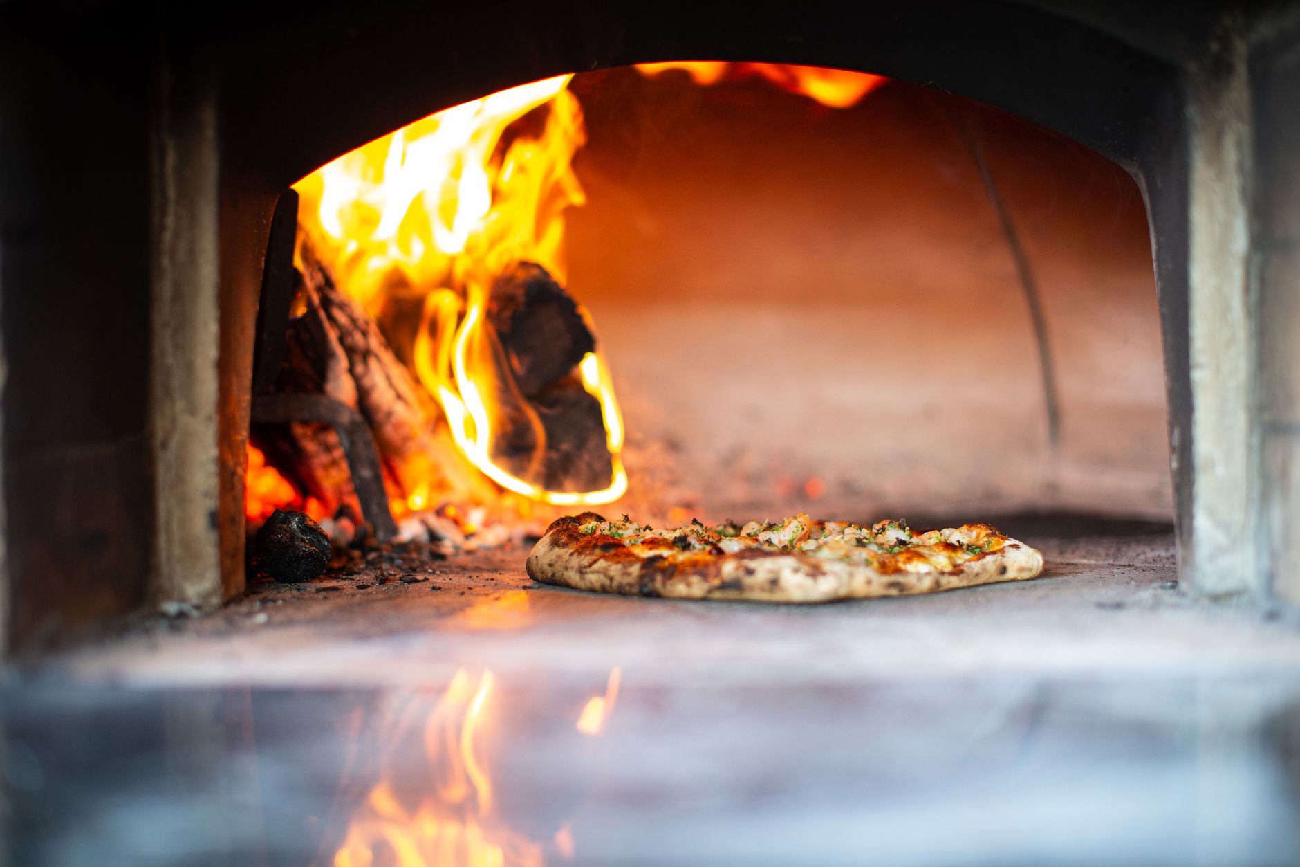 Wood-fired pizza oven with masonry chimney in a St. Louis backyard
